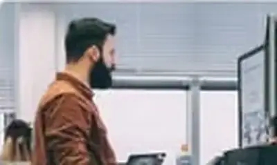 Man working at computer screens in an office